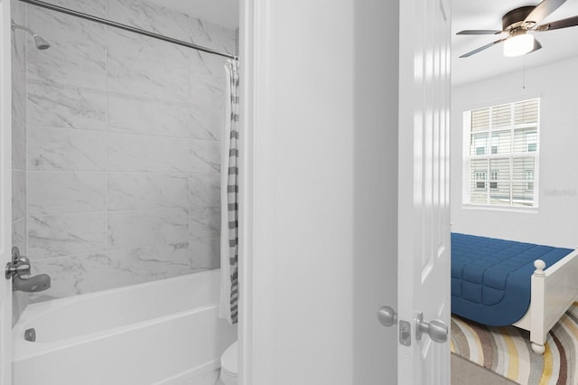 bathroom with toilet, a ceiling fan, and shower / tub combo with curtain