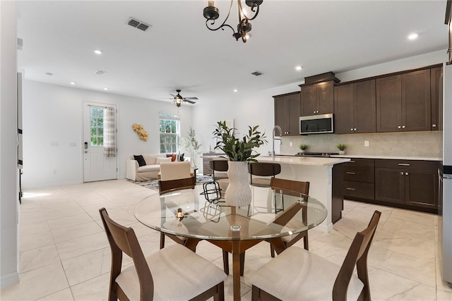 2097 Celebration Blvd, Celebration, FL 34747 - dining space featuring ceiling fan, recessed lighting, and a chandelier