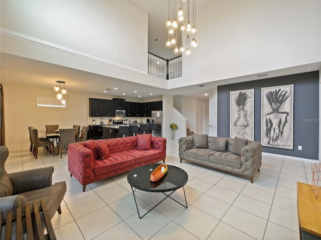 tiled living room with a high ceiling and a chandelier