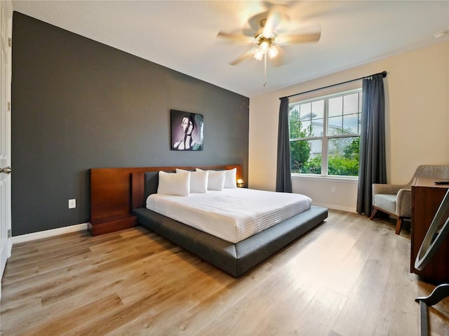 bedroom with ceiling fan and light wood-type flooring