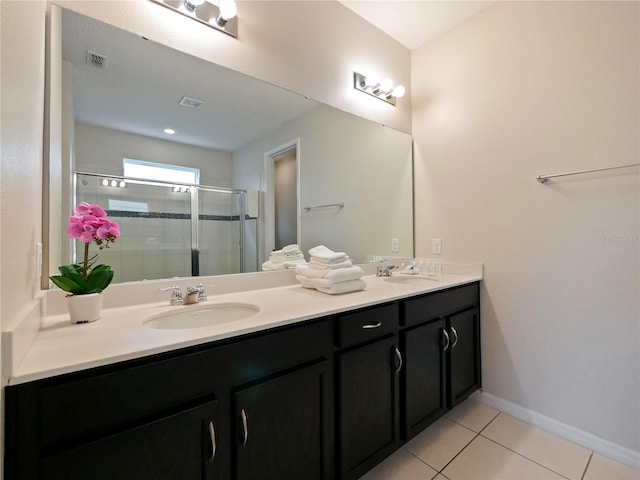 bathroom featuring tile patterned floors, vanity, and a shower with shower door