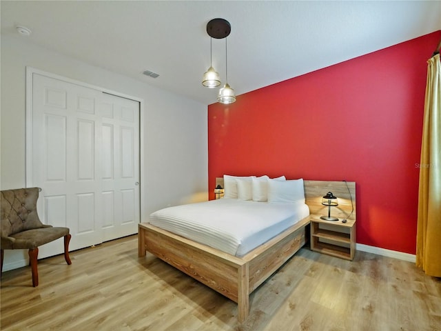 bedroom featuring light hardwood / wood-style flooring and a closet