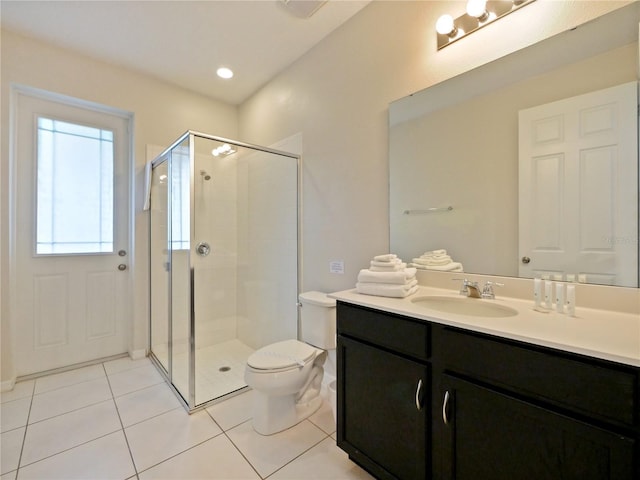 bathroom featuring tile patterned flooring, vanity, toilet, and an enclosed shower