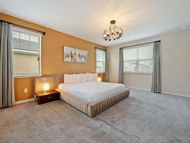 carpeted bedroom featuring a chandelier