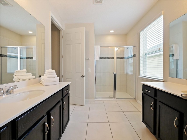 bathroom with tile patterned flooring, vanity, and an enclosed shower