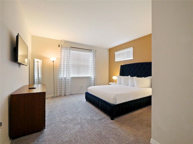 bedroom featuring light carpet