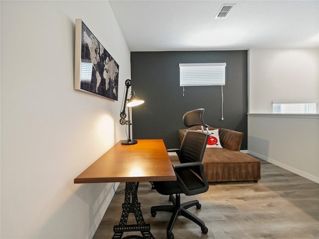 home office with hardwood / wood-style flooring