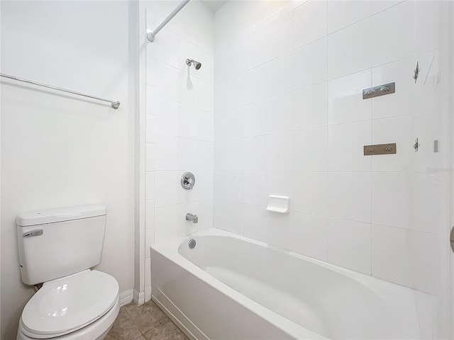 bathroom with washtub / shower combination, baseboards, toilet, and tile patterned floors