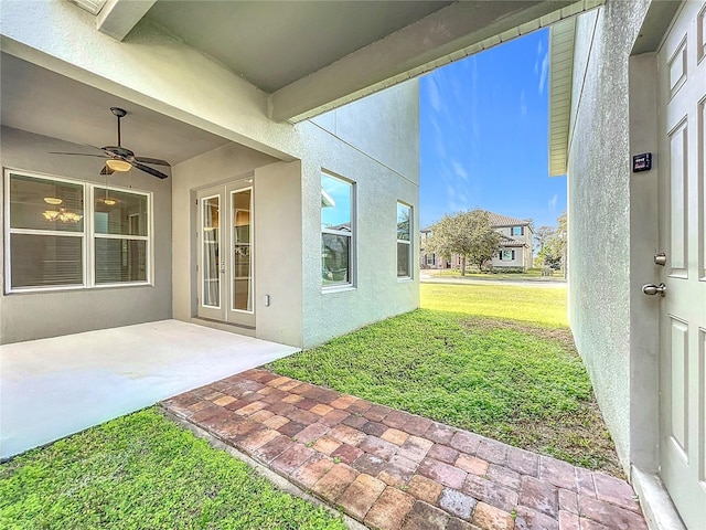 view of yard featuring a ceiling fan and a patio