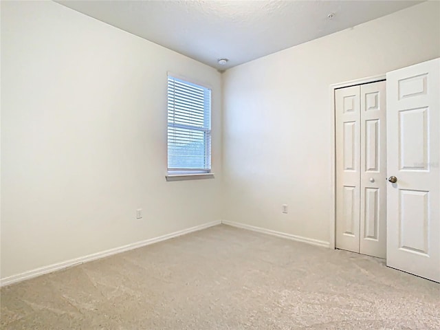 unfurnished bedroom with baseboards and a closet