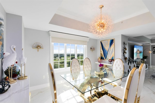 dining space featuring a tray ceiling and a chandelier