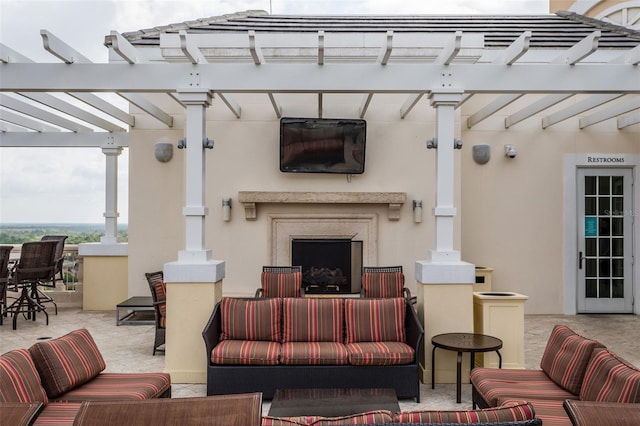 view of patio / terrace with an outdoor living space with a fireplace and a pergola