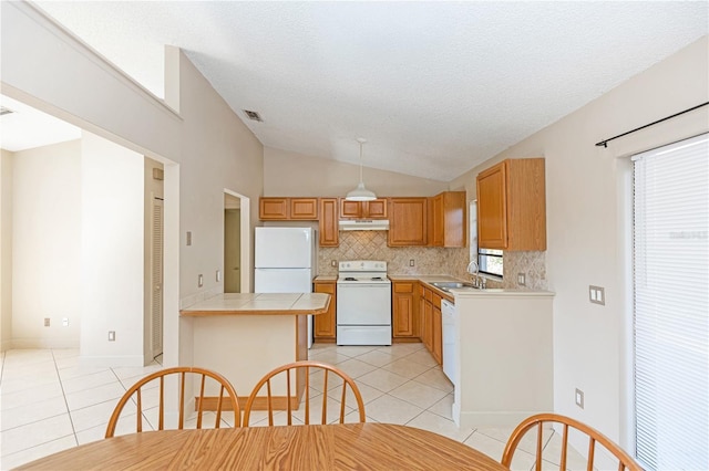 1073 Humphrey Blvd, Deltona, FL 32738 - kitchen with white appliances, light tile patterned floors, lofted ceiling, a sink, and decorative backsplash