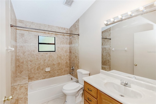 full bathroom with vanity, tiled shower / bath, vaulted ceiling, tile patterned flooring, and toilet