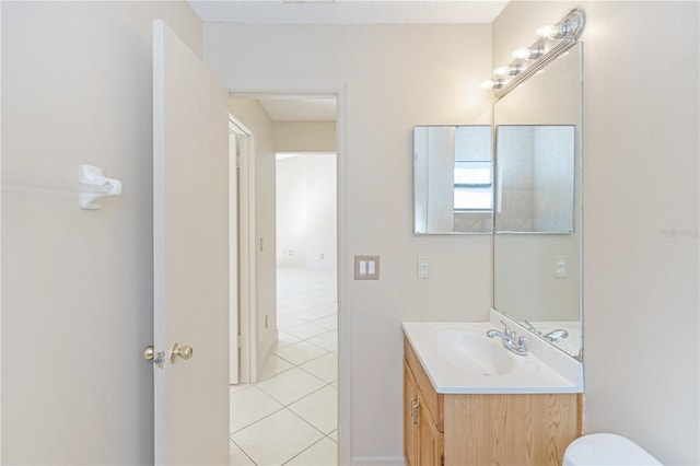 bathroom featuring tile patterned flooring and vanity