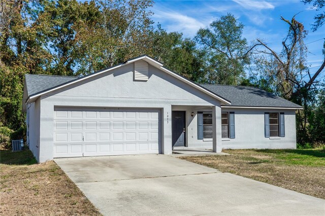 1073 Humphrey Blvd, Deltona, FL 32738 - single story home with stucco siding, a garage, driveway, roof with shingles, and a front yard