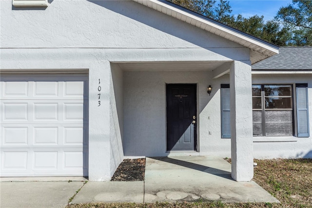 1073 Humphrey Blvd, Deltona, FL 32738 - property entrance with a garage, stucco siding, and a shingled roof
