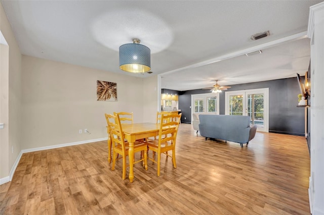 dining room featuring ceiling fan, light hardwood / wood-style flooring, and a textured ceiling