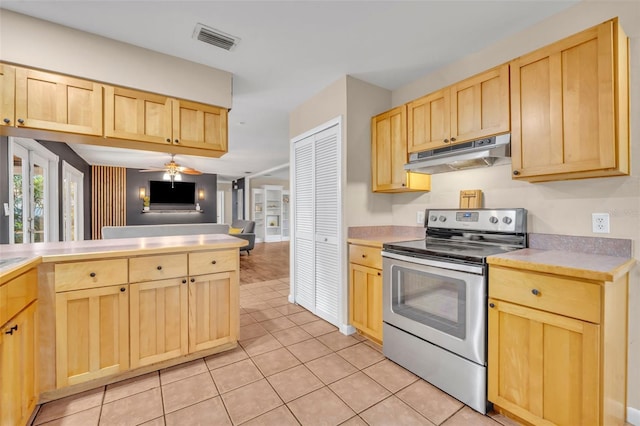 kitchen with ceiling fan, light tile patterned floors, electric stove, and light brown cabinetry