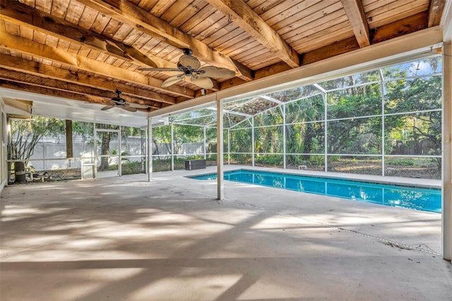 view of pool with glass enclosure, ceiling fan, and a patio area