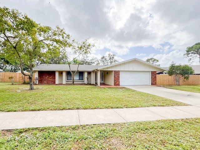 single story home featuring a garage and a front yard