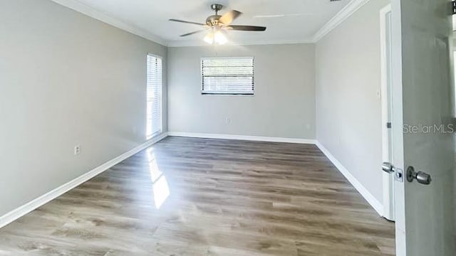 spare room featuring ornamental molding, dark wood-type flooring, and ceiling fan