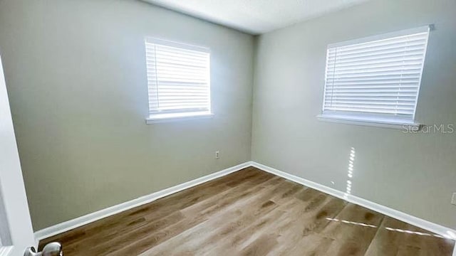 empty room featuring hardwood / wood-style flooring