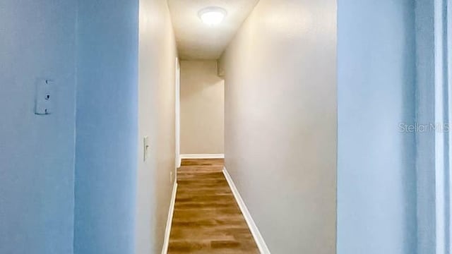 corridor with dark hardwood / wood-style floors