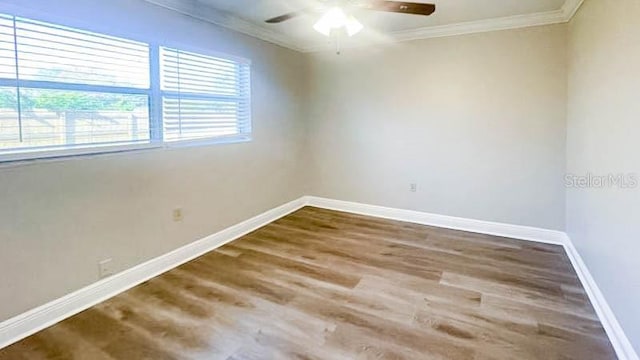 spare room featuring hardwood / wood-style floors, ornamental molding, and ceiling fan