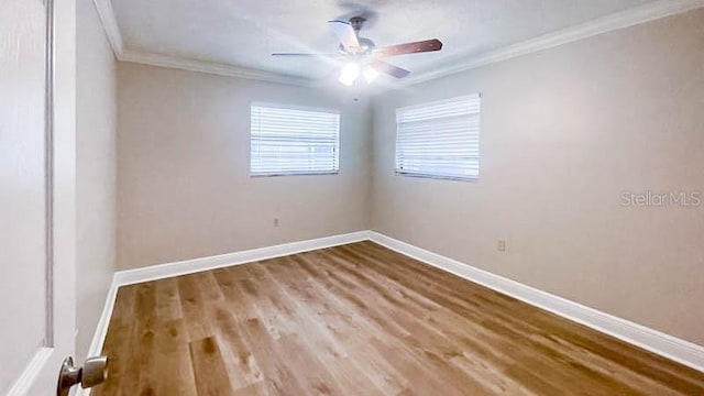 spare room featuring crown molding, ceiling fan, and wood-type flooring