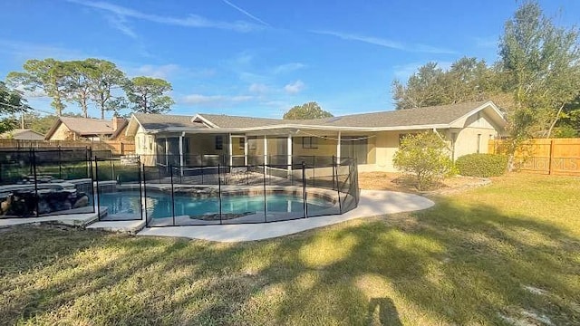 view of pool featuring a lawn