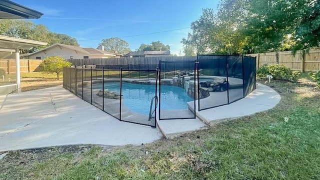 view of swimming pool featuring a yard and a patio