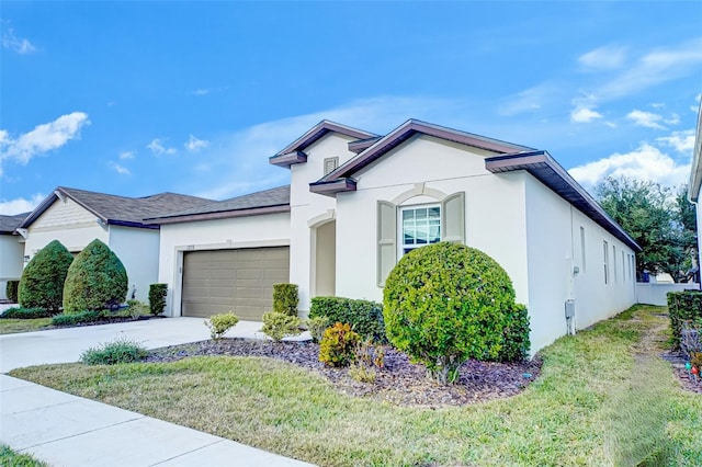 view of front facade with a garage and a front lawn