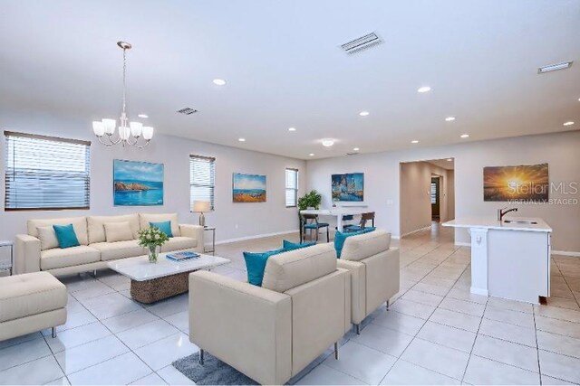 living room with plenty of natural light, light tile patterned floors, and an inviting chandelier