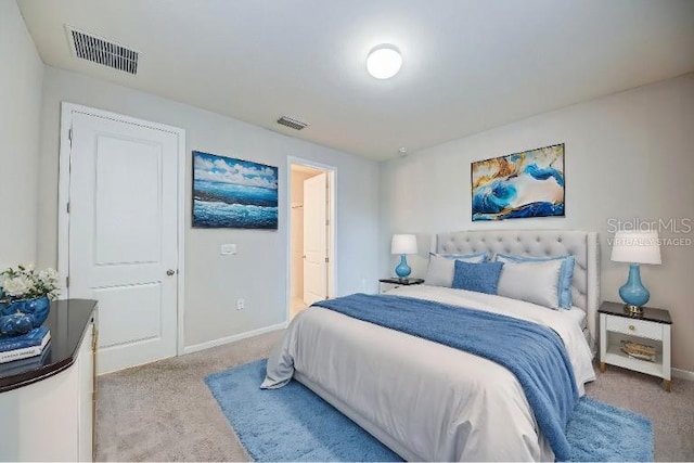 bedroom featuring light carpet