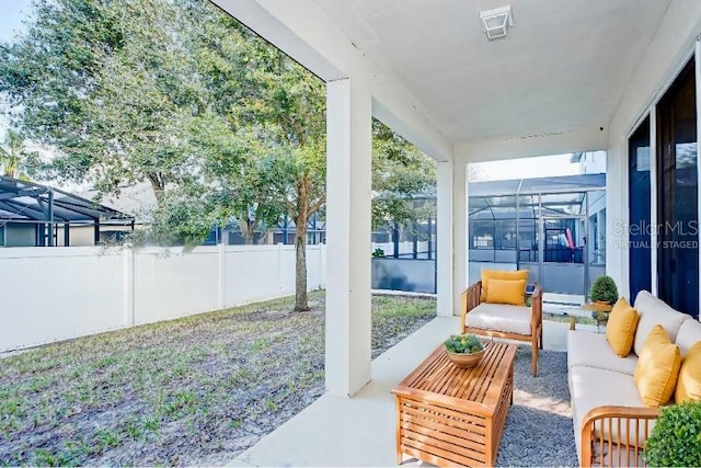 view of patio / terrace with an outdoor living space and glass enclosure