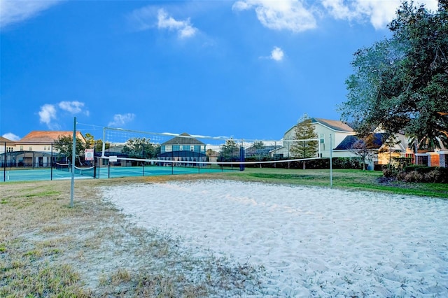 view of home's community with tennis court