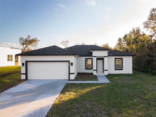 prairie-style home with a front yard and a garage