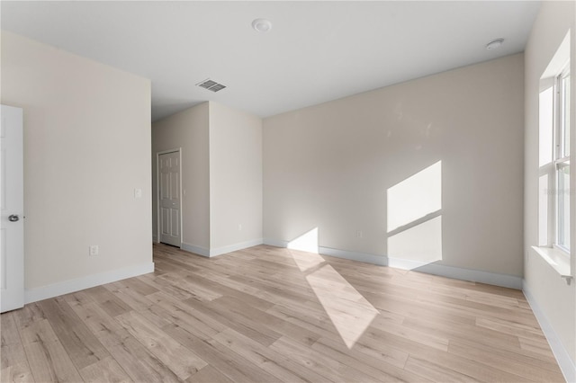 unfurnished room with light wood-type flooring