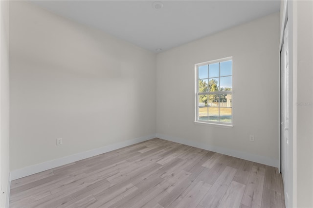 spare room with light hardwood / wood-style flooring