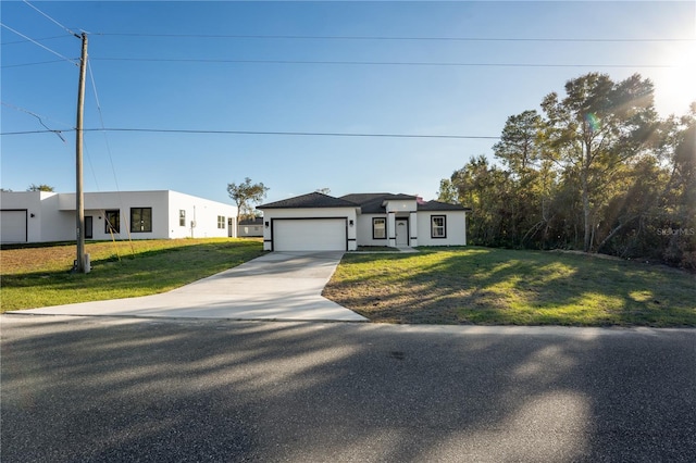 view of front of house with a garage and a front lawn