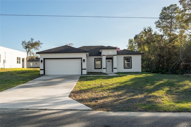 view of front of property with a garage and a front lawn