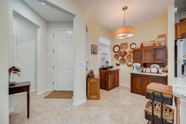 kitchen featuring decorative light fixtures and light tile patterned flooring