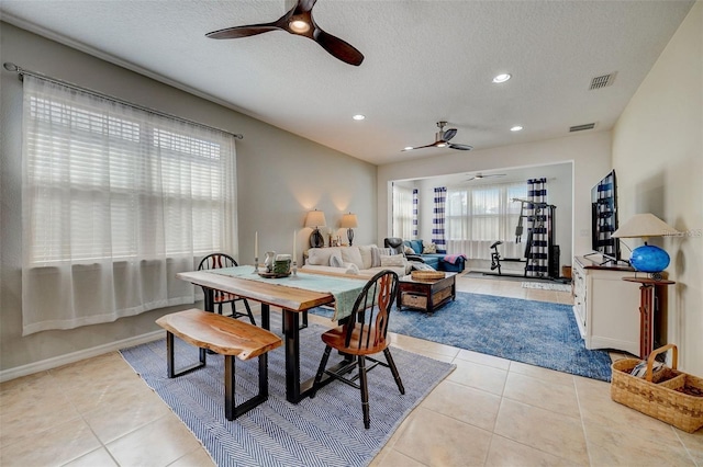 dining space featuring plenty of natural light, ceiling fan, and light tile patterned floors