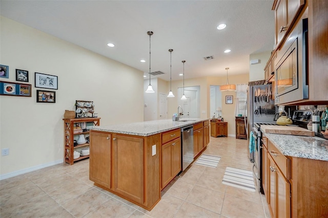 kitchen featuring a center island with sink, pendant lighting, sink, and appliances with stainless steel finishes