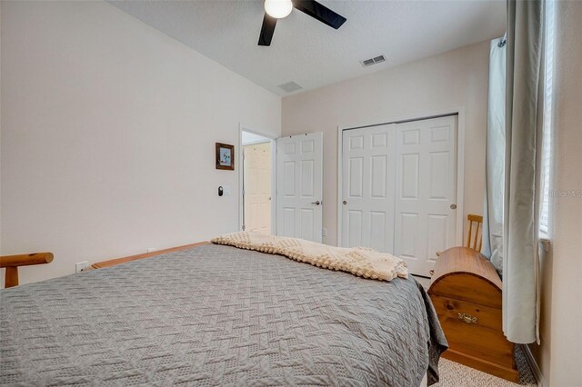 bedroom featuring carpet flooring, ceiling fan, a closet, and a textured ceiling