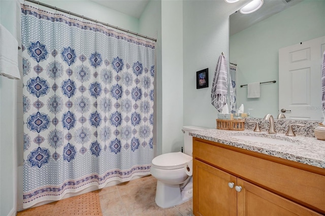 bathroom featuring tile patterned flooring, vanity, and toilet