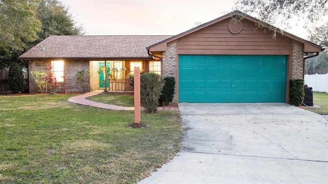 ranch-style home featuring a garage and a front yard