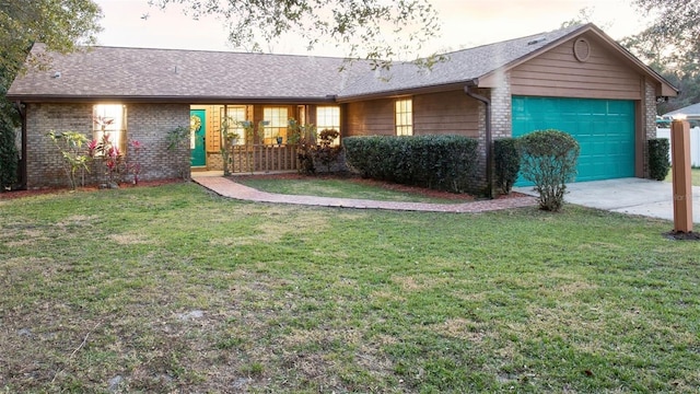 single story home featuring a garage and a front lawn