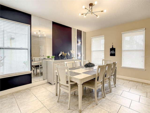 dining room featuring light tile patterned floors and an inviting chandelier